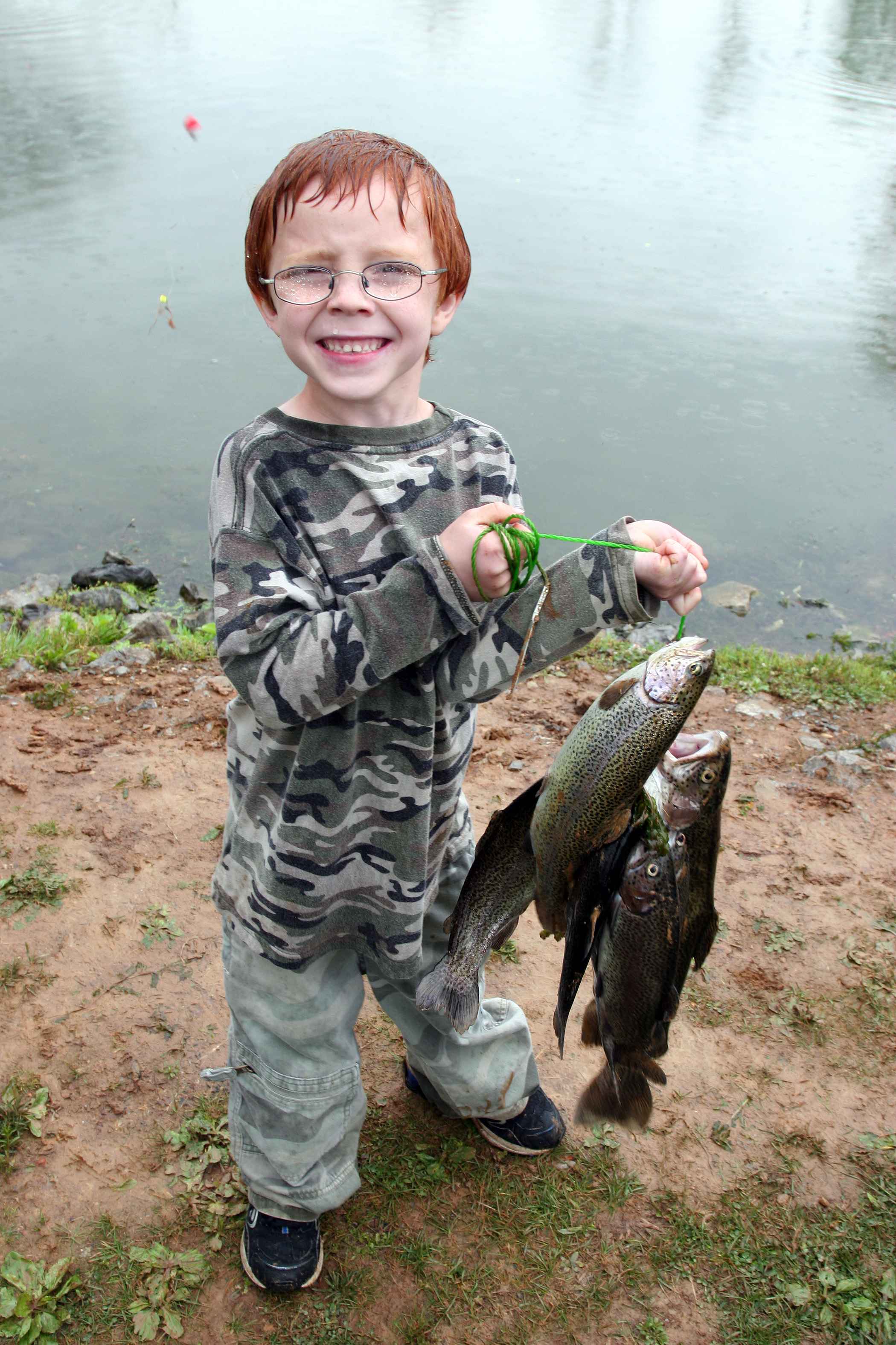 happy-boy-with-glasses-on-lake-shelbyville-fishing-proudly-holding-a-fish-catch